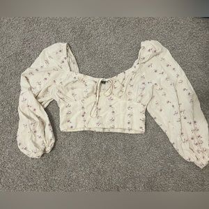 long sleeve corset-like crop top with flowers on it